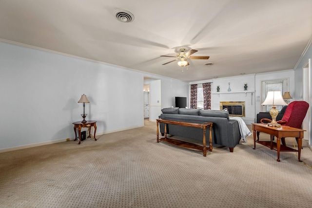 carpeted bedroom featuring ceiling fan, ornamental molding, and a brick fireplace