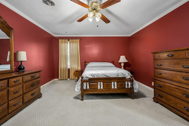 carpeted bedroom featuring ornamental molding and ceiling fan