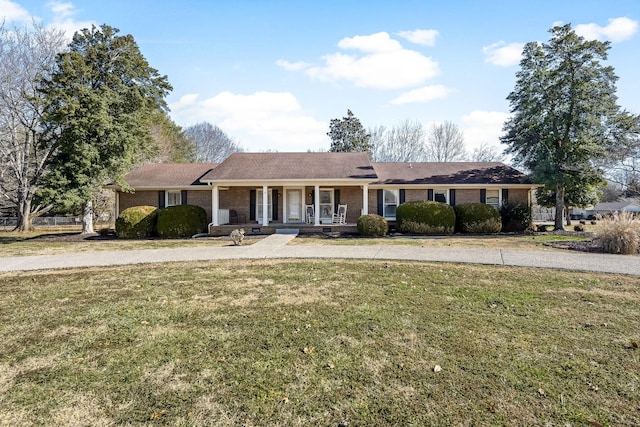 single story home with a porch and a front lawn