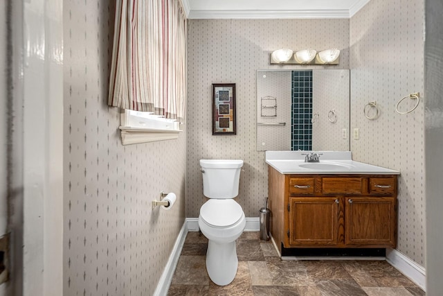 bathroom featuring vanity, ornamental molding, and toilet