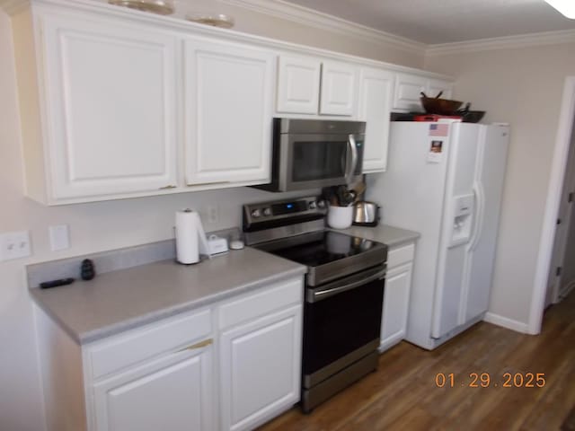 kitchen with white cabinetry, dark wood-type flooring, ornamental molding, and appliances with stainless steel finishes