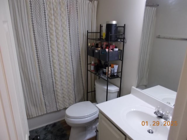 bathroom with vanity, walk in shower, and toilet