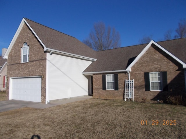 view of front of home with a garage and a front lawn