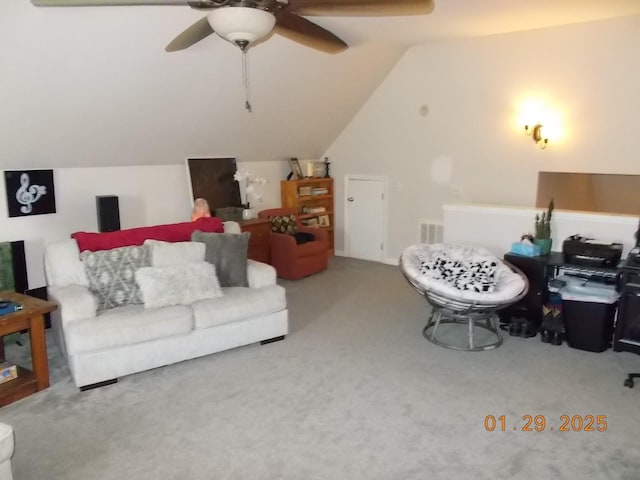 carpeted living room with ceiling fan and vaulted ceiling