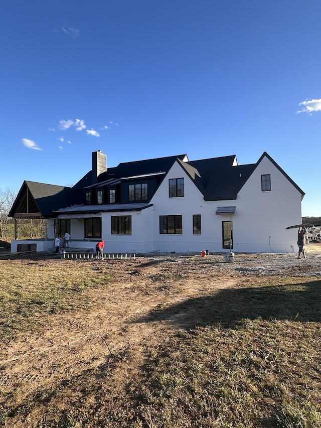 back of property featuring a chimney