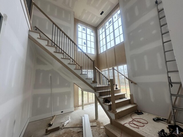 staircase with a high ceiling