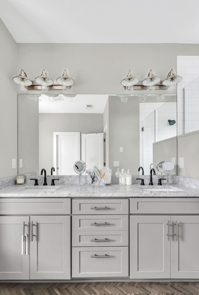 bathroom featuring vanity, parquet floors, and a shower with shower door