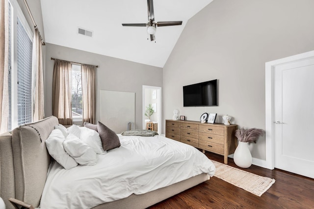 bedroom featuring ceiling fan, dark hardwood / wood-style floors, and high vaulted ceiling