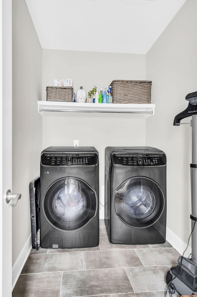 clothes washing area with washing machine and dryer and a wood stove