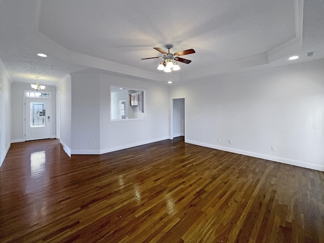 unfurnished living room featuring a textured ceiling, ceiling fan with notable chandelier, dark hardwood / wood-style floors, and a raised ceiling