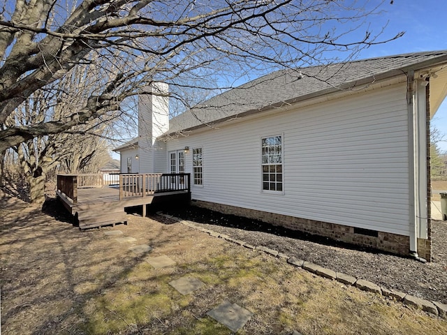 view of property exterior with a wooden deck