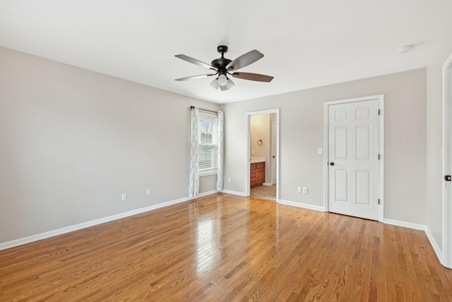 unfurnished bedroom with ensuite bathroom, ceiling fan, and light hardwood / wood-style flooring