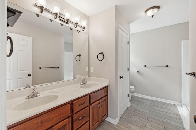 bathroom featuring vanity and toilet