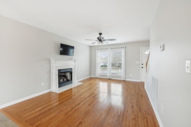 unfurnished living room with ceiling fan and light wood-type flooring