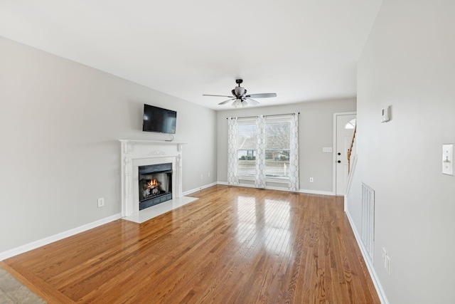 unfurnished living room with ceiling fan and light hardwood / wood-style floors