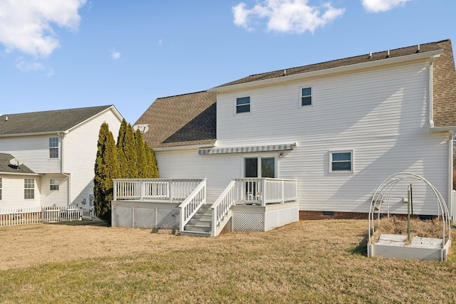 back of house with a deck and a lawn