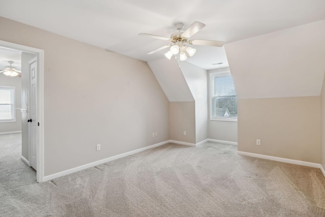 bonus room featuring ceiling fan, light colored carpet, and vaulted ceiling