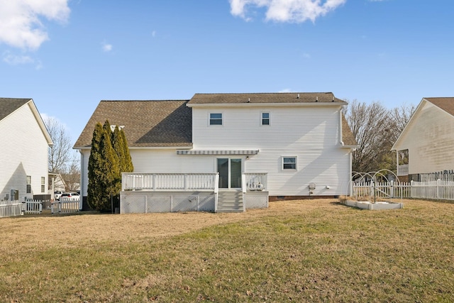 rear view of house with a lawn and a deck