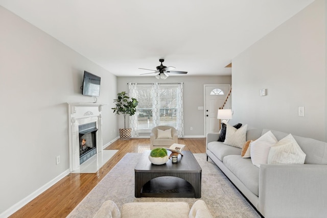 living room with ceiling fan and light wood-type flooring