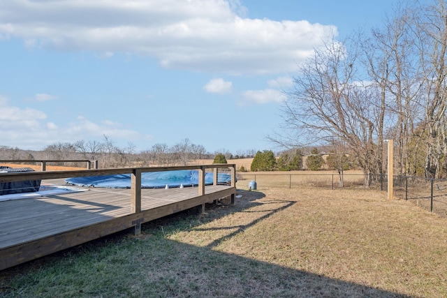 dock area with a yard, a rural view, and a deck