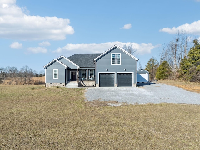 rear view of house featuring a garage, a porch, and a yard