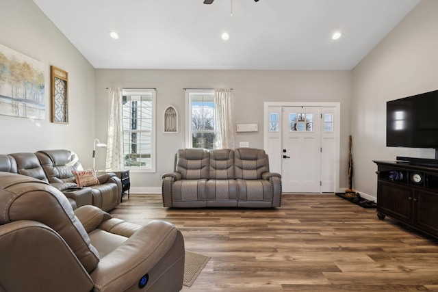 living room with ceiling fan, wood-type flooring, and vaulted ceiling