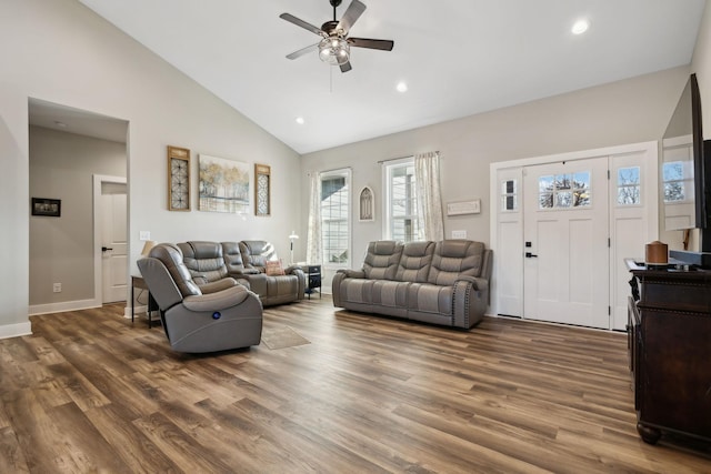 living room featuring dark wood-type flooring, ceiling fan, and high vaulted ceiling