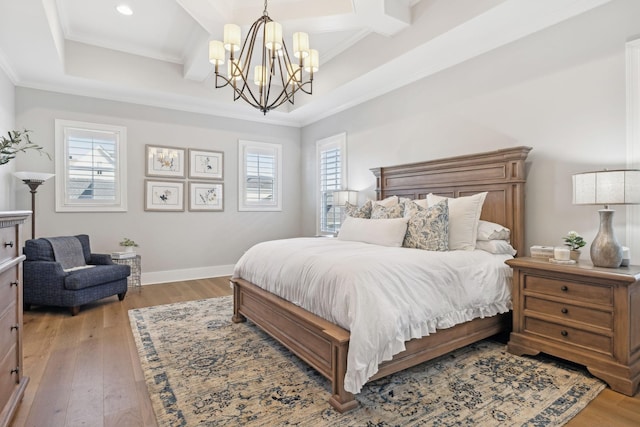 bedroom featuring multiple windows, coffered ceiling, and light wood-type flooring