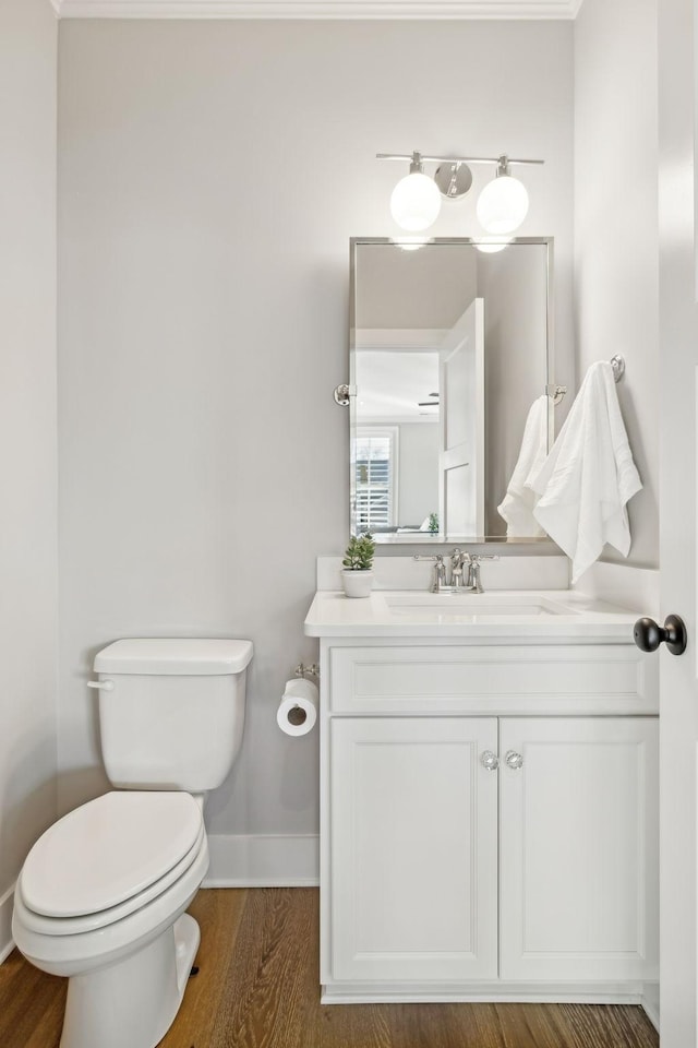 bathroom featuring vanity, hardwood / wood-style floors, and toilet