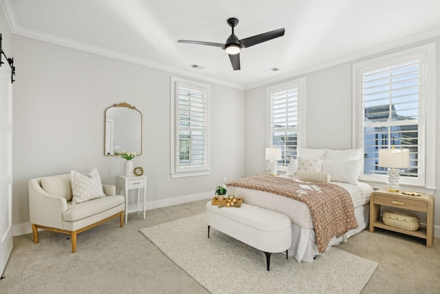 bedroom featuring ceiling fan, light colored carpet, ornamental molding, and a barn door