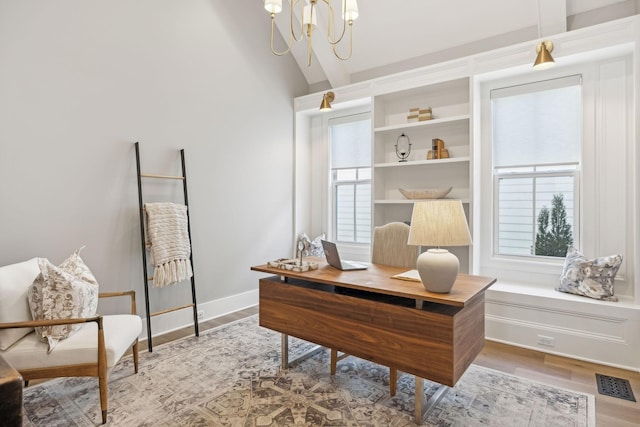 office with an inviting chandelier and light wood-type flooring