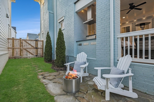 view of patio / terrace featuring a fire pit and ceiling fan