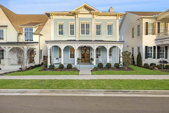 view of front of home featuring a front yard and covered porch