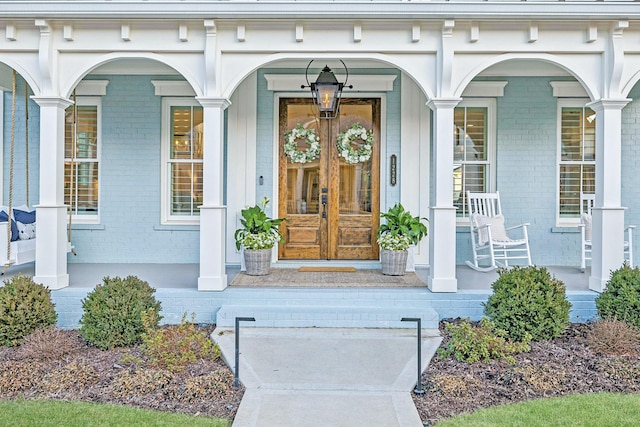 property entrance featuring french doors and covered porch