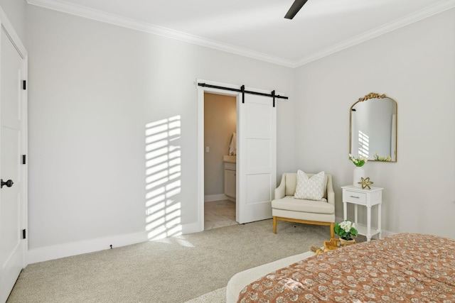 bedroom with crown molding, ceiling fan, ensuite bathroom, carpet floors, and a barn door