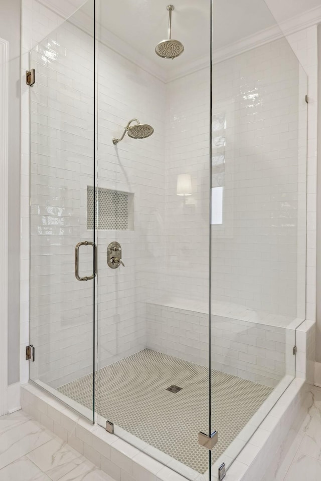 bathroom with an enclosed shower and crown molding