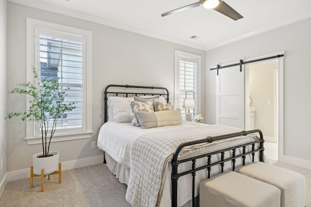 bedroom featuring a barn door, carpet floors, and multiple windows