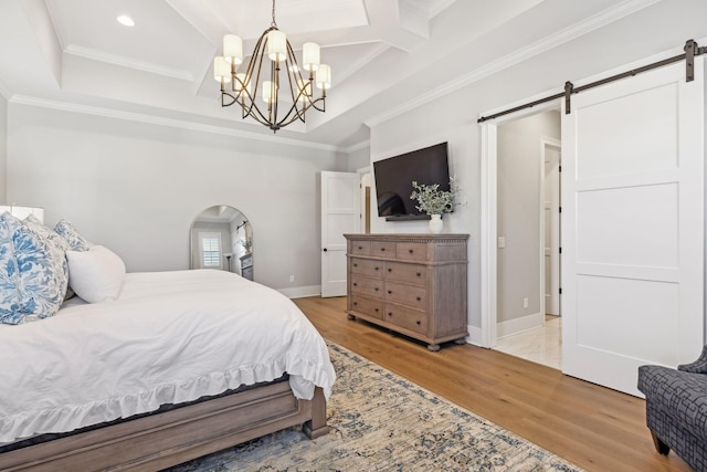 bedroom featuring coffered ceiling, wood-type flooring, ornamental molding, a notable chandelier, and a barn door