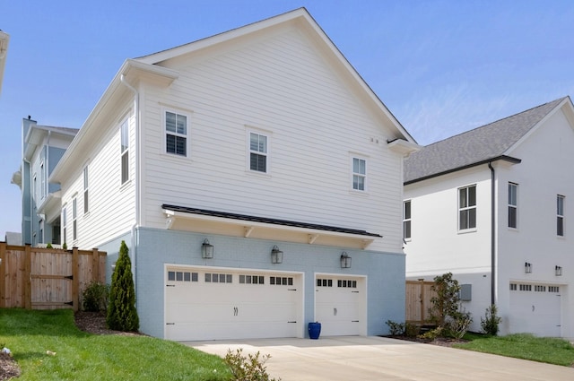 exterior space featuring a garage and a lawn