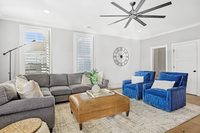 living room featuring ceiling fan, ornamental molding, and hardwood / wood-style floors