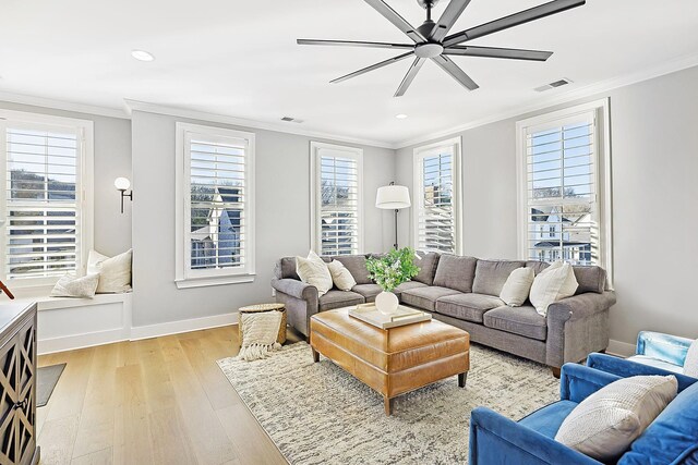 living room featuring crown molding, ceiling fan, and light hardwood / wood-style flooring