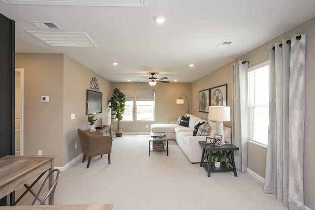 carpeted living room with plenty of natural light and ceiling fan