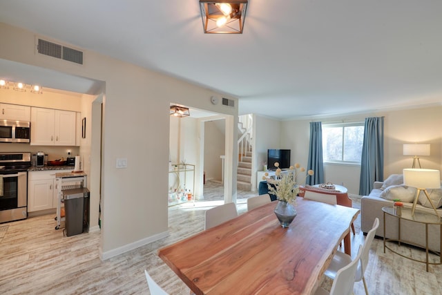 dining space featuring light wood-type flooring