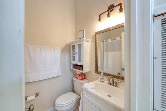 bathroom featuring vanity, curtained shower, and toilet