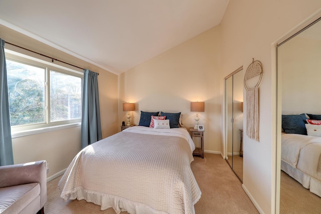 bedroom with vaulted ceiling and light carpet