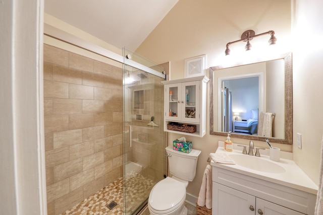 bathroom featuring lofted ceiling, vanity, toilet, and walk in shower