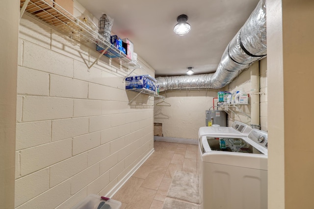 washroom featuring washing machine and dryer and electric water heater