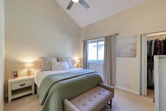 carpeted bedroom featuring ceiling fan, a spacious closet, high vaulted ceiling, and a closet