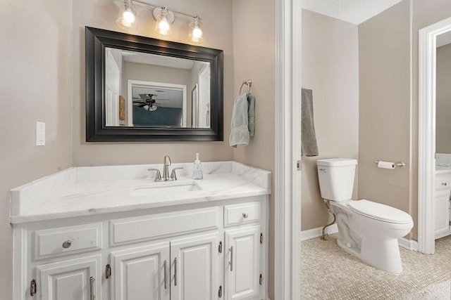 bathroom with vanity, toilet, and tile patterned flooring