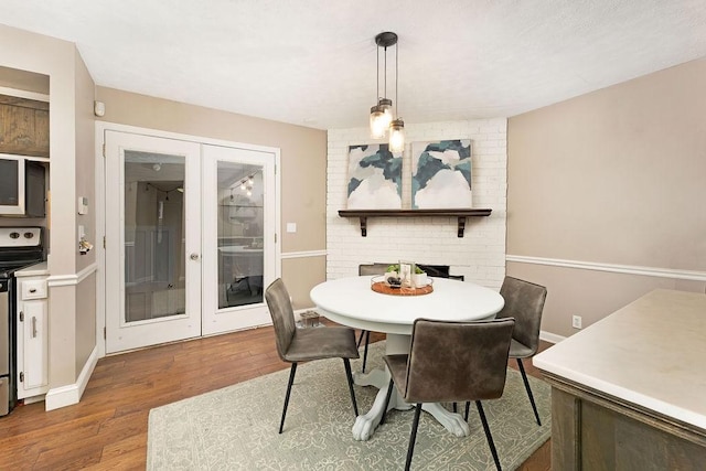 dining room with french doors and wood-type flooring